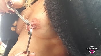 Sexy wife shows off extreme nipple piercings with hooks outdoors