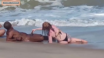 Amateur couple engages in public sex with a stranger on the beach